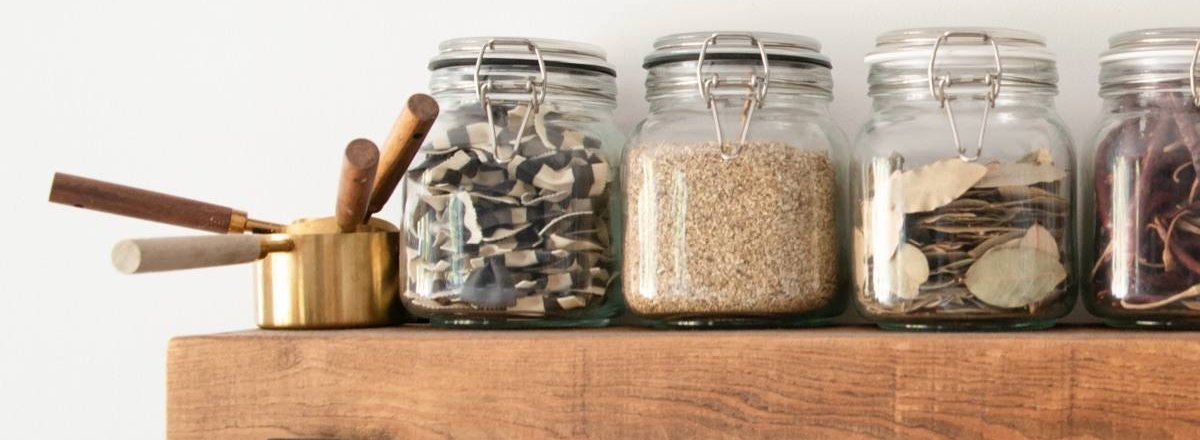 Pantry jars on a wooden shelf